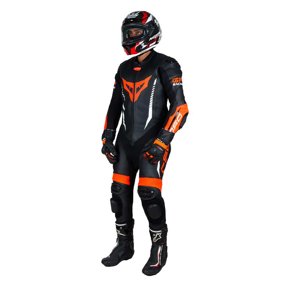 Angled view of a rider wearing the DSG GP Racing Leather Suit in black and orange fluo
