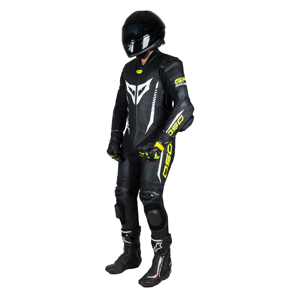 Angled view of a rider wearing the DSG GP Racing Leather Suit in black and yellow fluo